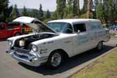 Photo of a sharp white 1957 Chevy Sedan Delivery with great racing graphics, setup for vintage racing
